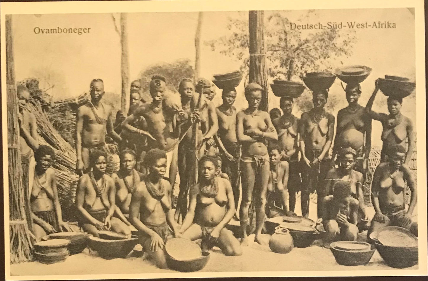 PC 0057 GSWA postcard - labourers showing off their harvest - Owambo tribe /